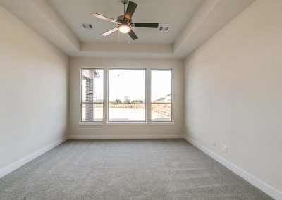 carpeted room with ceiling fan