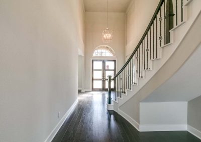 hallway with stair case and front door