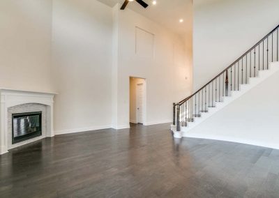 Expansive entryway with staircase and fireplace.